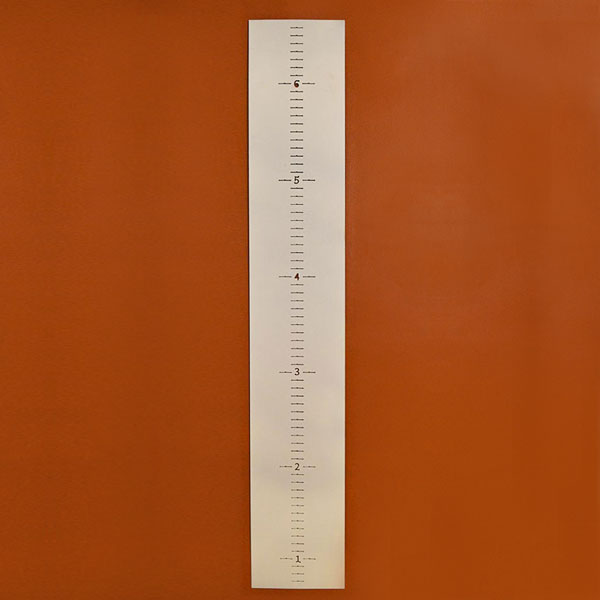 wide steel growth chart on wall